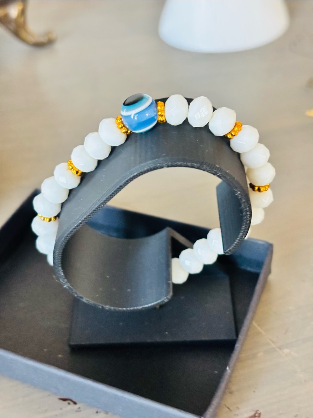 Claire's White Beaded Bracelet with Blue Evil Eye and Gold Accents